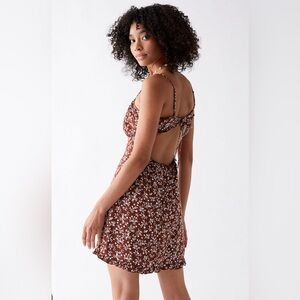 A cute little brown dress with flower details. Size is XS